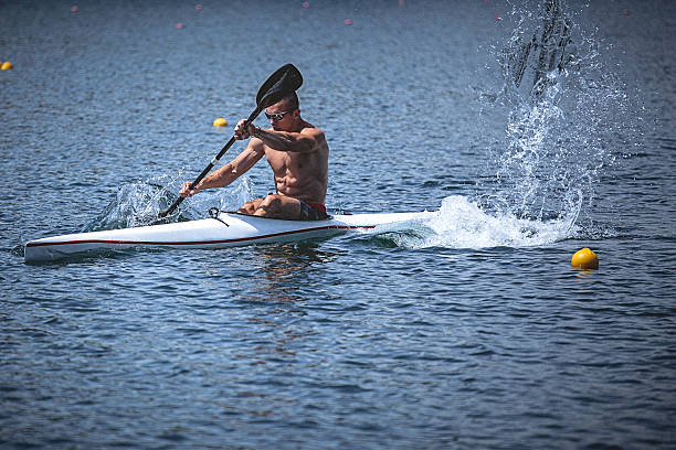 istock Young muscular man during kayak sprint training on still water. 538804466