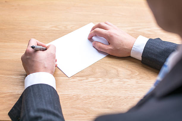 istock businessman writing on white paper on table 538807294