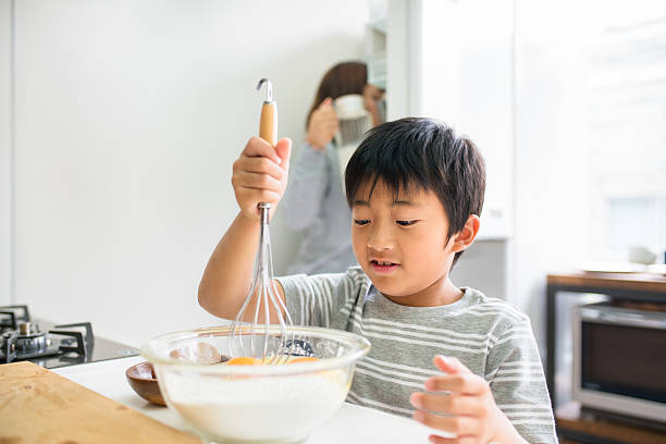 istock Young boy helping his mother in the kitchen 538807912