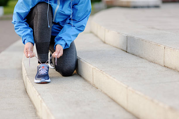 istock Woman runner tying laces before training. Marathon. 538808498