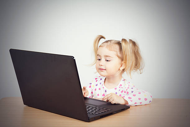istock little girl at the computer. 538810756