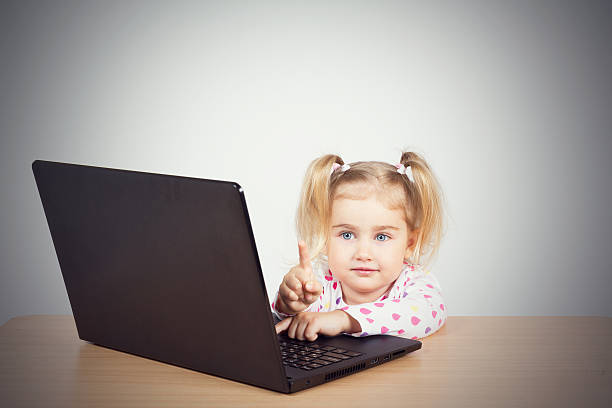 istock little girl at the computer. 538810834