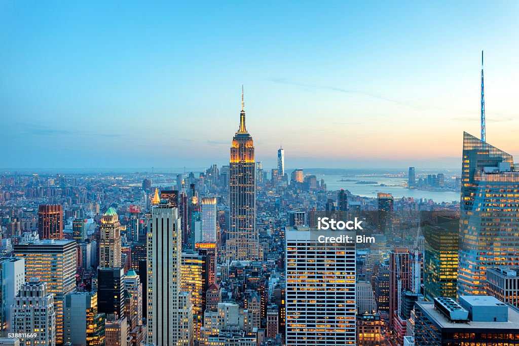 Manhattan panorama with its skyscrapers illuminated at dusk, New York illuminated skyscrapers in Manhattan at evening with Empire State Building and Freedom Tower - the new World Trade Center, New York City New York City Stock Photo