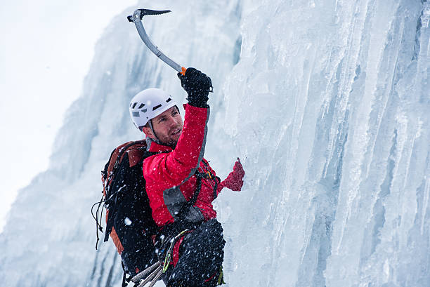Ice climber ascending a frozen waterfall.