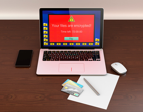 Screen of laptop computer showing alert that the computer was attacked by ransomware. 3D rendering image with clipping path.