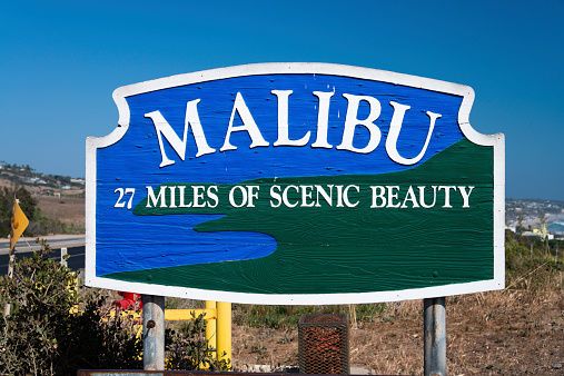 Malibu, California, USA - May 26, 2014: Malibu road sign as seen from the Pacific coast highway during a hot summer day.