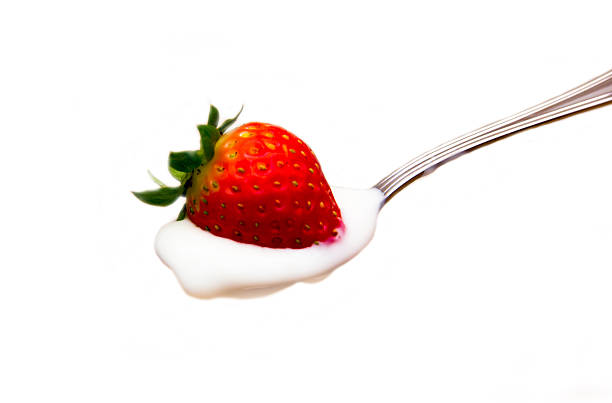 istock Yogurt with strawberry on spoon close 538812333