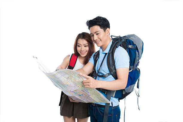 istock Asian tourists traveling and holding a map 538812340