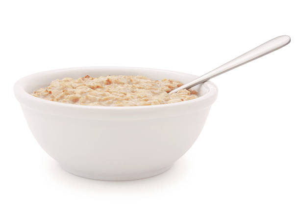 ciotola di farina d'avena e cucchiaio (con percorso) - oatmeal porridge bowl spoon foto e immagini stock