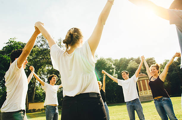 istock Friends holding hands in the park 538813273