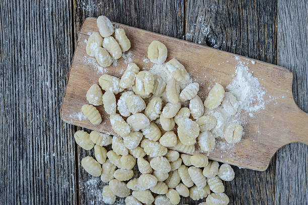 istock Gnocchi on Cutting Board and Rustic Wood Background 538815283