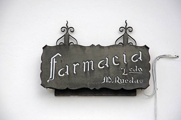 Casares, Spain - March 16, 2011: Rustic metal pharmacy sign on a wall, Casares, Cadiz Province, Costa del Sol, Malaga Province, Andalusia, Spain, Western Europe.