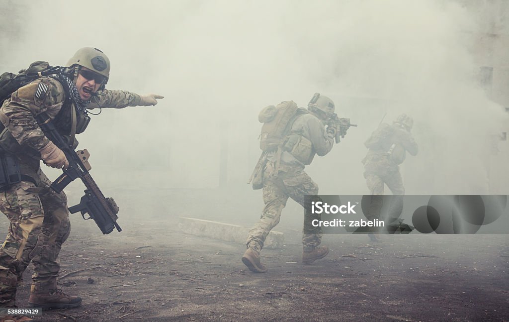 United States Army rangers in action United States Army rangers during the military operation in the smoke and fire War Stock Photo