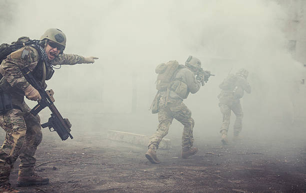 United States Army rangers in action United States Army rangers during the military operation in the smoke and fire war stock pictures, royalty-free photos & images