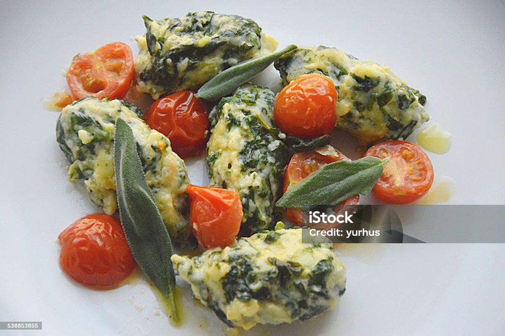 Spinach gnocchi with tomatoes and salvia Spinach gnocchi Austrian art 2015 Stock Photo