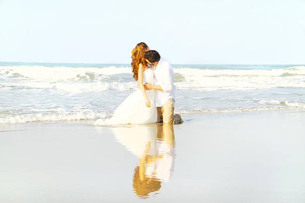 istock Bride and groom at beach 538859123