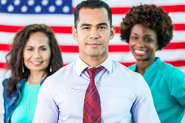 istock Hispanic Man with team in front of American flag 538862282