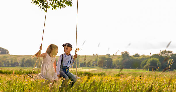 istock Boy and girl looking at each other while swinging 538867224