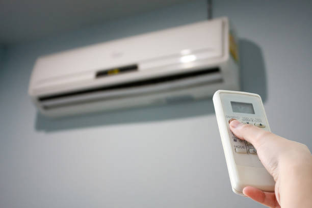 istock Hand with remote control directed on the air conditioner 538868426