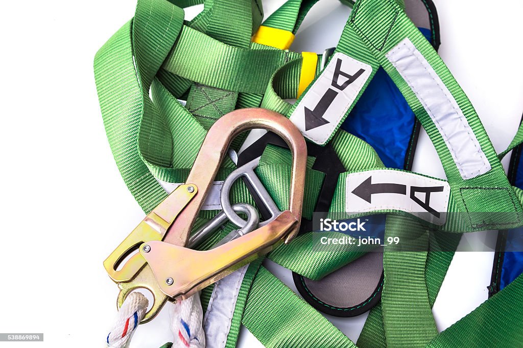 Closeup fall protection harness and lanyard for work at heights Closeup fall protection harness and lanyard for work at heights on white background.Closeup at safety hook. Falling Stock Photo