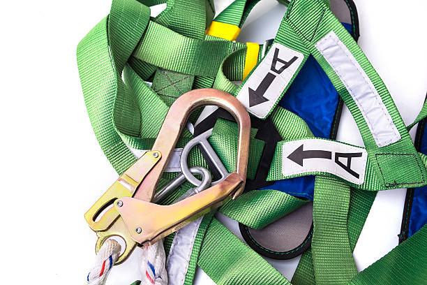 Closeup fall protection harness and lanyard for work at heights Closeup fall protection harness and lanyard for work at heights on white background.Closeup at safety hook. safety harness stock pictures, royalty-free photos & images