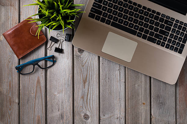 istock Overhead shot of office table with computer and plant 538871352