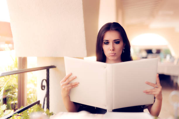 istock Sad Woman Choosing from Restaurant Menu 538871564