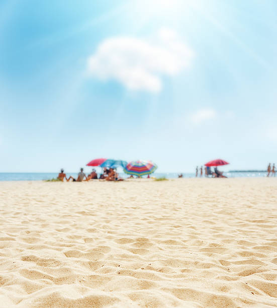 sand on beach closeup and sun in blue  sky