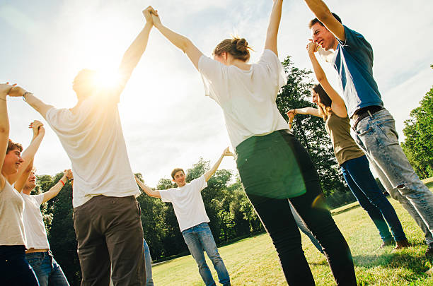 istock Friends holding hands in the park 538876055