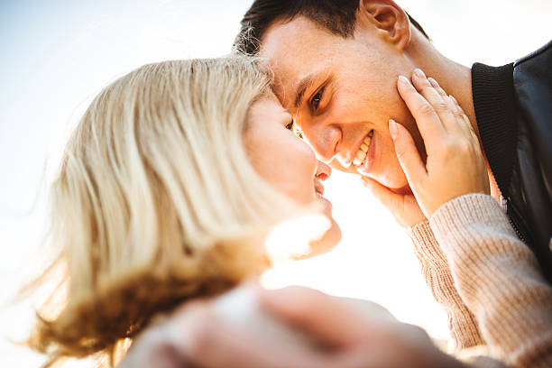 istock romantic couple enjoying the sunset embracing 538876067