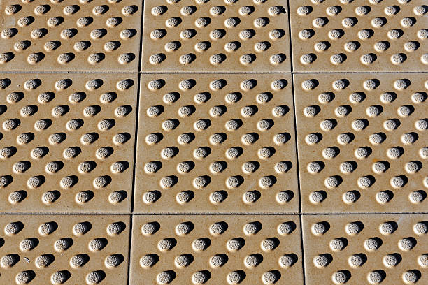 detail of tactile markings for blind people with white cane on a railway platform; Germany