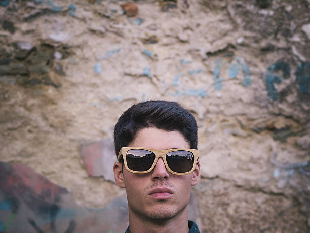 istock Fashionable man portrait over ruinous wall background 538876925