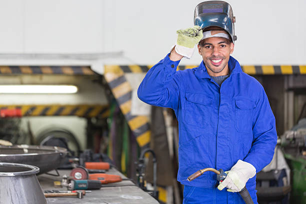 Professional welder posing with wellding machine Professional welder posing with wellding machine and torch welding mask stock pictures, royalty-free photos & images