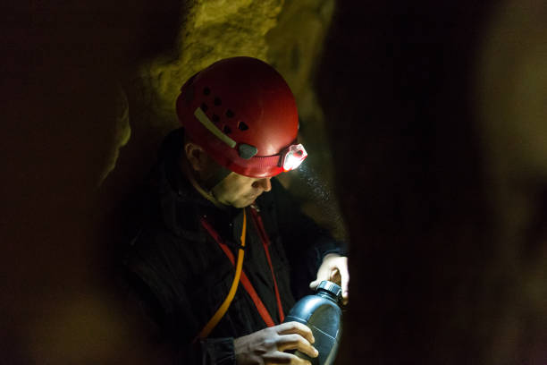 istock explorer - speleology male resting and drinking water 538879138