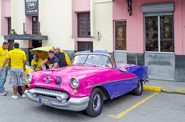 Havana, Cuba - November 29, 2015: American classic car and Their owner and guides waiting for hire to tourists in Old Havana.