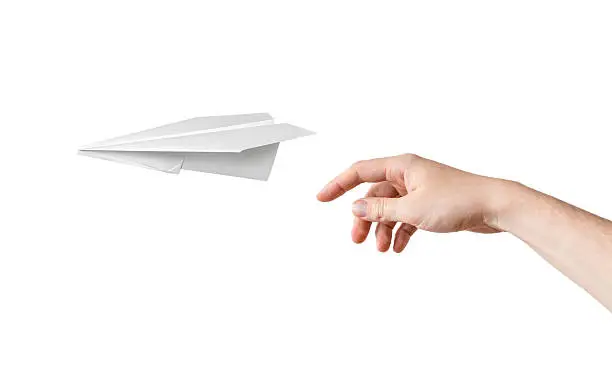 Photo of Hand is throwing origami paper airplane. Isolated on white background.