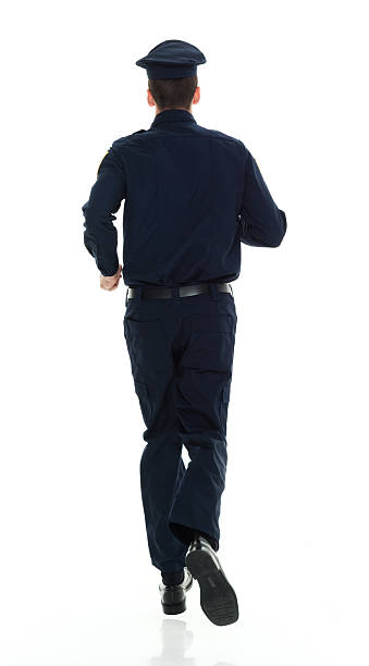 istock Rear view of police running 538879968