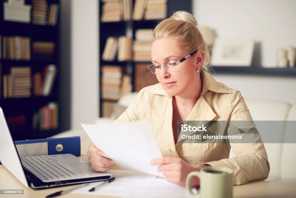 blonde woman working at home 2015 Stock Photo