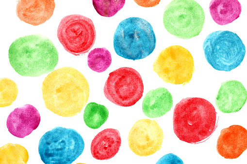 Circles painted with watercolors on white sheet.