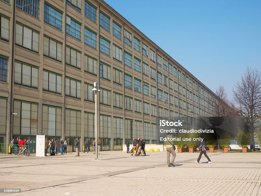 Fiat Lingotto Turin Turin, Italy - February 19, 2015: Tourists visiting the Fiat Lingotto car factory designed by Trucco in 1916 now turned into an exhibition centre and shopping mall 1916 Stock Photo