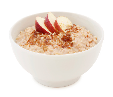 Oatmeal, apple slices and brown sugar bowl isolated on white (excluding the shadow)