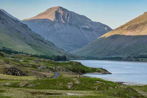 An evening view of Great Gable in the English Lake District. The photograph features the mountain with evening sunlight hitting the peak and part of Wastwater lake.