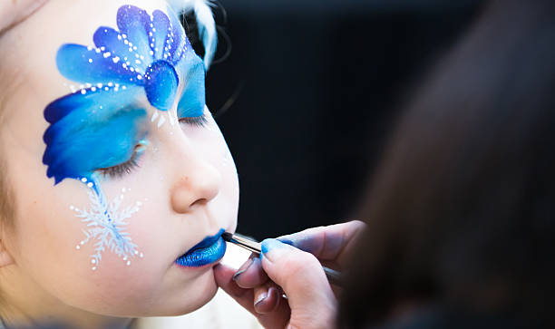 Portrait of little girl during the face painting session Christmas face painting, Portrait of little girl during the face painting session face paint stock pictures, royalty-free photos & images