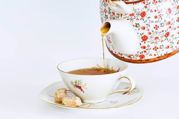 istock Teapot pouring tea into a cup of tea 538884180