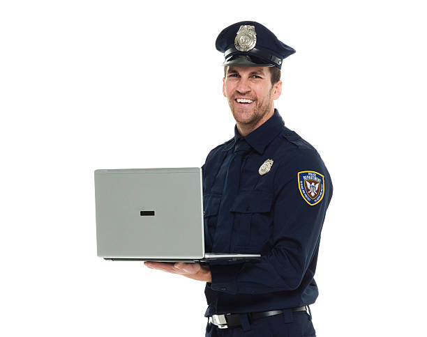 istock Cheerful police working on laptop 538884744