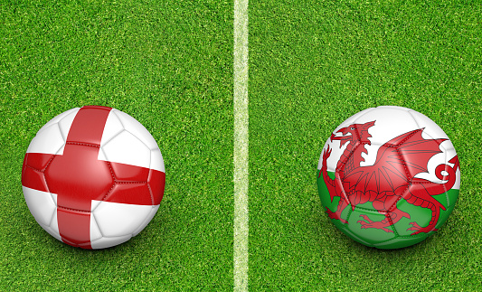 Stadium grass and two football designs for teams England and Wales competing in a championship tournament.