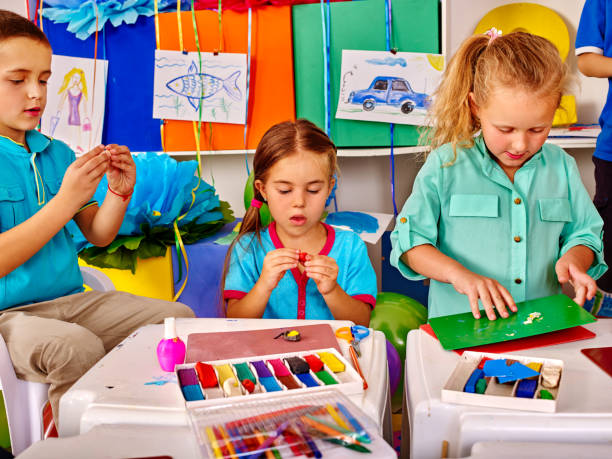 istock Group kids mold from plasticine in kindergarten . 538887868