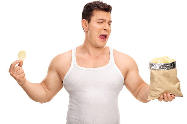 istock Displeased guy holding a bag of chips 538888598