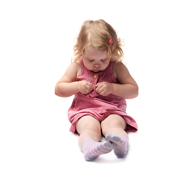 istock Young little girl sitting over isolated white background 538890160