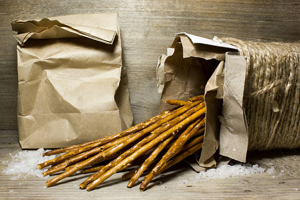 istock Bread sticks with salt in Kraft box on wooden background 538890420